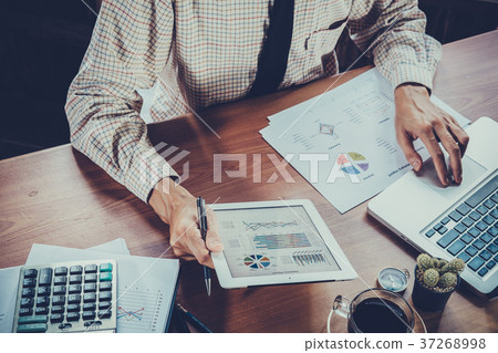 Businessman analyzing financial figures Businessman analyzing financial figures 37268998