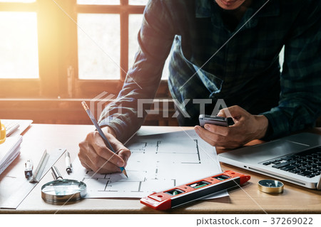 Architect designer hand working with smartphone Architect designer hand working with smartphone 37269022