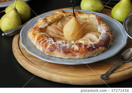 Homemade galette with pears on black background. 37271438