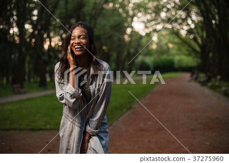 Young and beautiful black girl talking on the 37275960