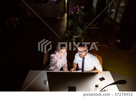 Businesspeople in the office at night working late 37278452