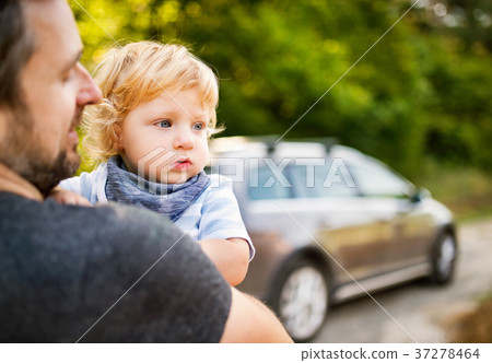 Young father with his little son going into the 37278464