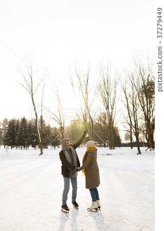 Senior couple in sunny winter nature ice skating. Senior couple in sunny winter nature ice skating. 37279449