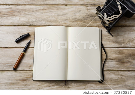 blank notebook, pen and old camera 37280857