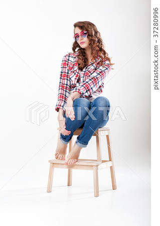 woman in jeans, plaid shirt and sunglasses 37280996