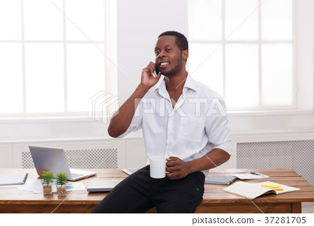 Young black businessman talking on mobile in Young black businessman talking on mobile in 37281705