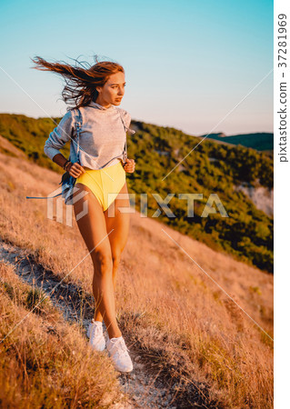 Beautiful sporty woman in nature at warm sunset Beautiful sporty woman in nature at warm sunset 37281969