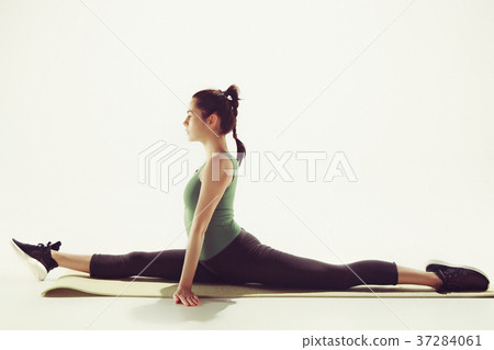 Beautiful slim brunette doing some stretching 37284061