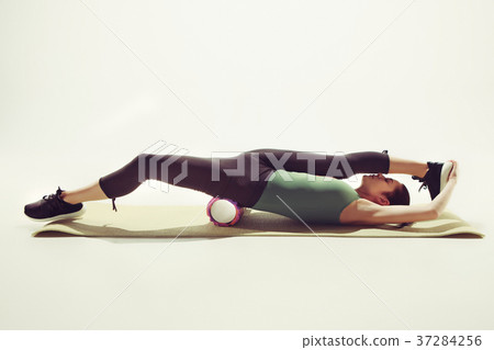 Beautiful slim brunette doing some stretching Beautiful slim brunette doing some stretching 37284256