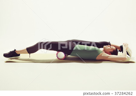 Beautiful slim brunette doing some stretching Beautiful slim brunette doing some stretching 37284262