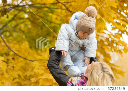 Young mother rising baby up. Concept of happy 37284849