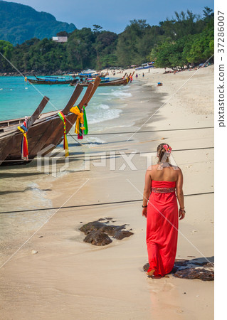 .Woman on Tropical beach relaxing and watching .Woman on Tropical beach relaxing and watching 37286007