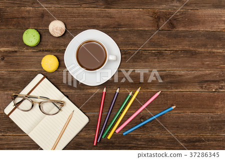 Coffee mug, macaroons, colored pencils Coffee mug, macaroons, colored pencils 37286345