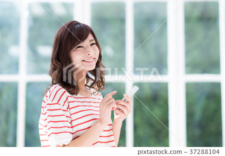 A young lady (a smartphone) A young lady (a smartphone) 37288104