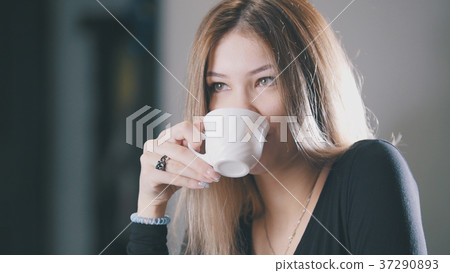 Pretty blonde young woman drinking coffee and 37290893