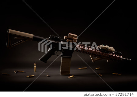 assault rifle and golden bullets on a black background 37291714