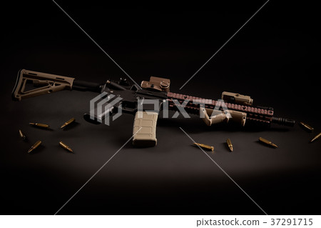 assault rifle and golden bullets on a black background 37291715