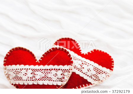 Two red felt hearts with laces, symbol of love Two red felt hearts with laces, symbol of love 37292179
