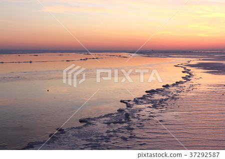 Sunset on a river covered with ice Sunset on a river covered with ice 37292587