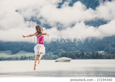 Woman jumping at the lake Woman jumping at the lake 37294360