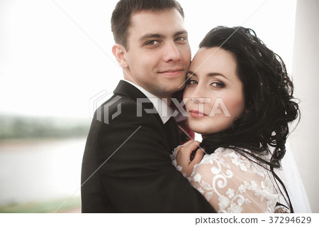 Elegant young happy wedding couple Elegant young happy wedding couple 37294629