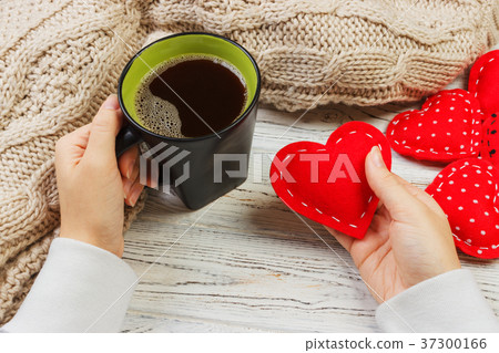 female hand holding hot cup of coffee female hand holding hot cup of coffee 37300166