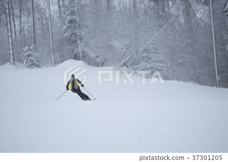 Skier on piste running downhill Skier on piste running downhill 37301205