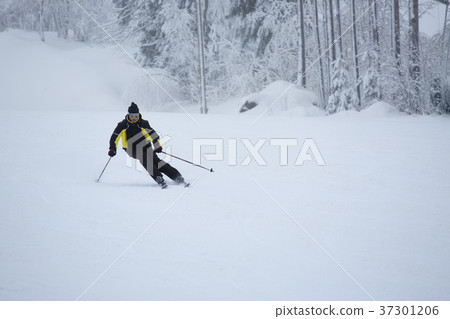Skier on piste running downhill Skier on piste running downhill 37301206