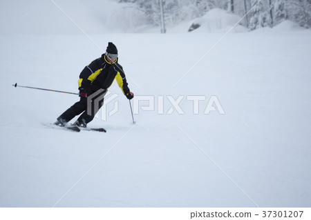 Skier on piste running downhill Skier on piste running downhill 37301207