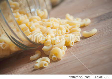 pasta in glass containers on wooden cutting board 37301229