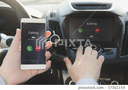 Man using phone calling system in car 37302159