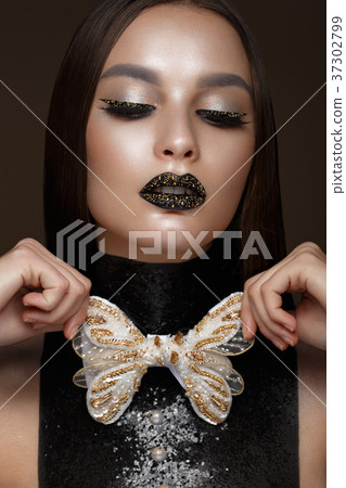 Beautiful girl with black creative art make-up and 37302799
