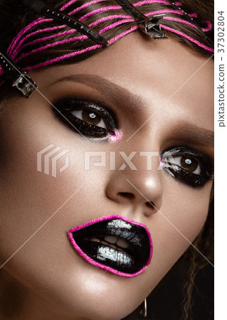 A beautiful girl with a black creative make-up and A beautiful girl with a black creative make-up and 37302804