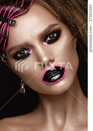 A beautiful girl with a black creative make-up and A beautiful girl with a black creative make-up and 37302805