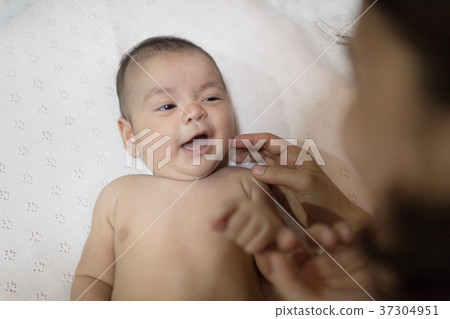 Portrait of a newborn Asian baby on the bed. 37304951