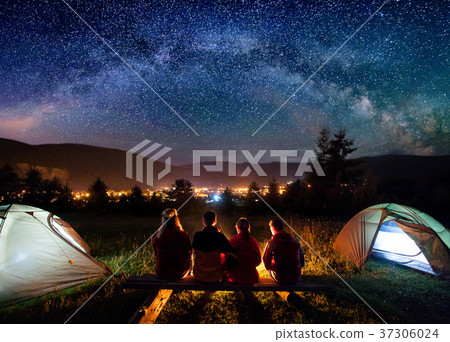 Silhouette of people sitting in the camp in night 37306024