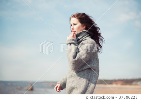 Attractive woman wearing a warm cardigan at the 37306223