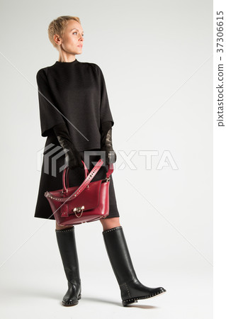 A girl in boots with thorns and a red bag A girl in boots with thorns and a red bag 37306615