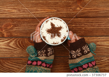 Woman hands hold full latte cappuccino coffee cup Woman hands hold full latte cappuccino coffee cup 37306737