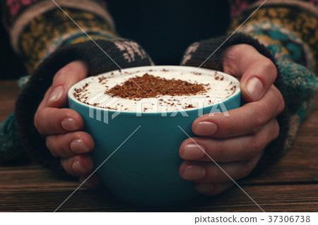 Woman hands hold full latte cappuccino coffee cup Woman hands hold full latte cappuccino coffee cup 37306738