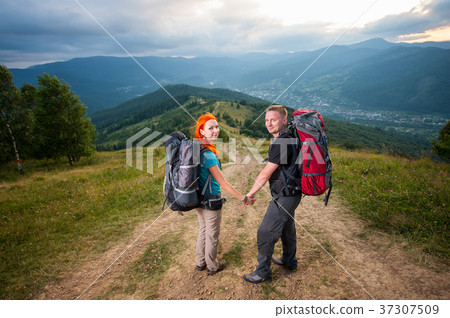 Young couple tourists traveling in the mountains 37307509
