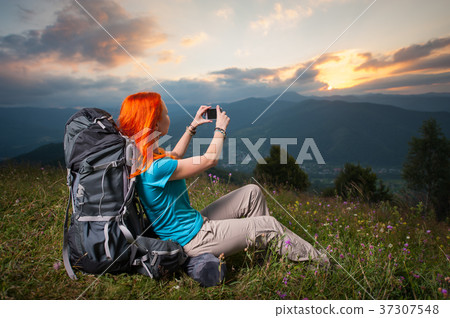 Happy female hiker traveling in the mountains Happy female hiker traveling in the mountains 37307548