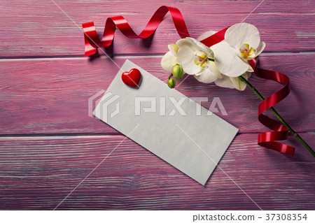 White Orchid and envelope on a pink wooden 37308354
