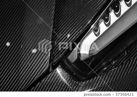 Headlight mounted in carbon fiber of sports car Headlight mounted in carbon fiber of sports car 37308421