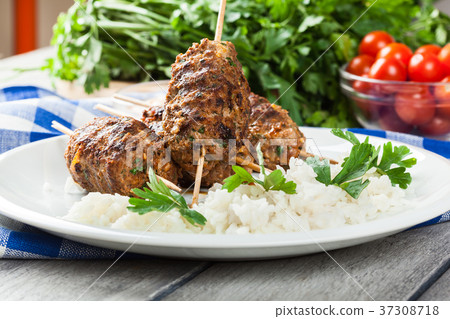 Barbecued kofta with rice on a plate 37308718