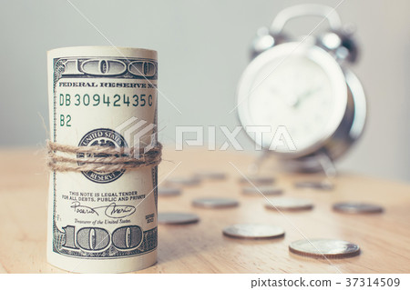Roll money dollar banknote with coins and clock Roll money dollar banknote with coins and clock 37314509