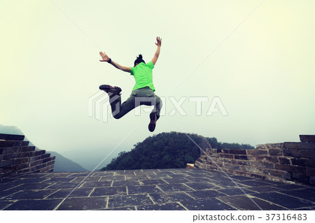 successful woman hiker jumping on great wall successful woman hiker jumping on great wall 37316483