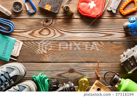 Travel items for hiking over wooden background 37318194