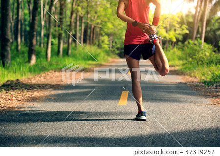 woman runner warming up before run on  trail 37319252