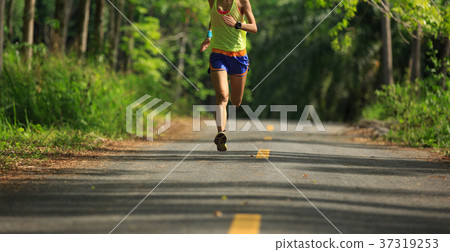 woman runner running on tropical forest trail 37319253
